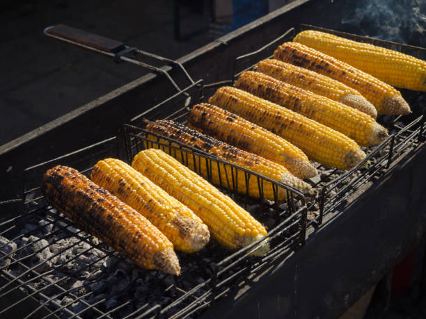 istock Barbecue cooking. Cooking juicy corn on the grill. 1062417044