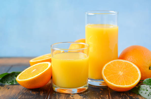 istock Fresh orange juice on old wooden table. 1062417244