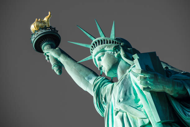 Portrait Statue of Liberty at perfect weather conditions blue sky copper torch stock photo