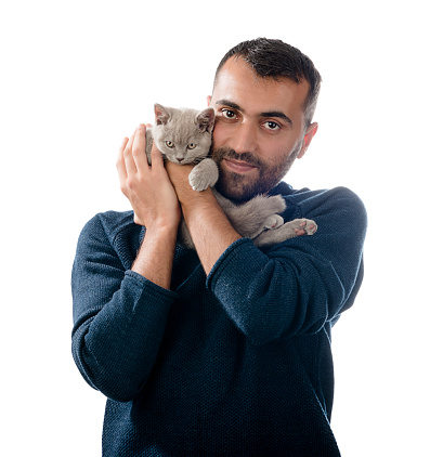 Adult man holding Scottish Fold cat isolated on white background.