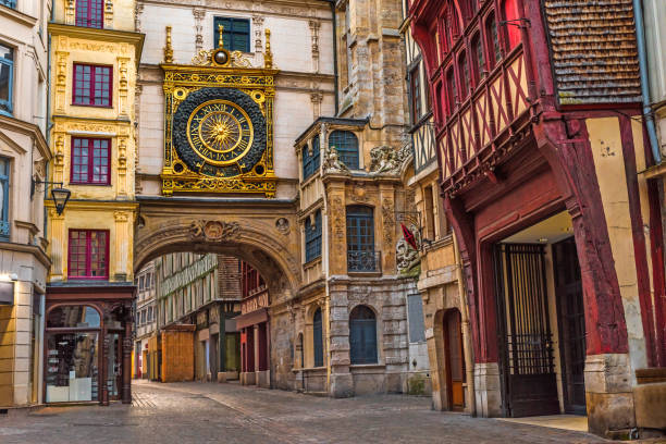 old cozy street in Rouen with famos Great clocks or Gros Horloge of Rouen, Normandy,France old cozy street in Rouen with famos Great clocks or Gros Horloge of Rouen, Normandy, France with nobody rue du gros horloge photos stock pictures, royalty-free photos & images