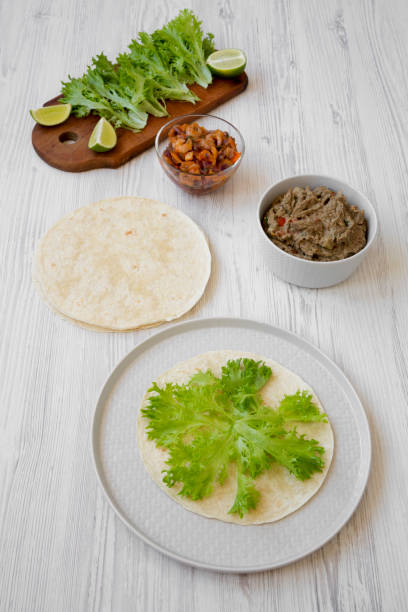 istock Making shrimp tacos on white wooden background, high angle view. Mexican kitchen. 1062419482