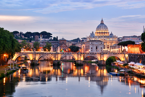 St. Peter's Basilica in Vatican and Tiber river in Rome at sunset