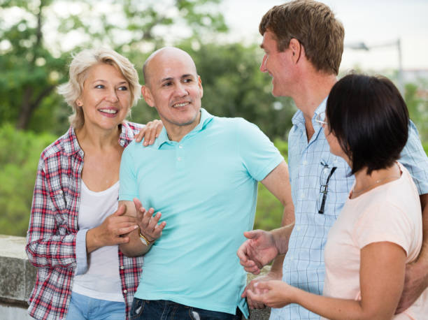 istock glad pensioners talking in the park 1062421524