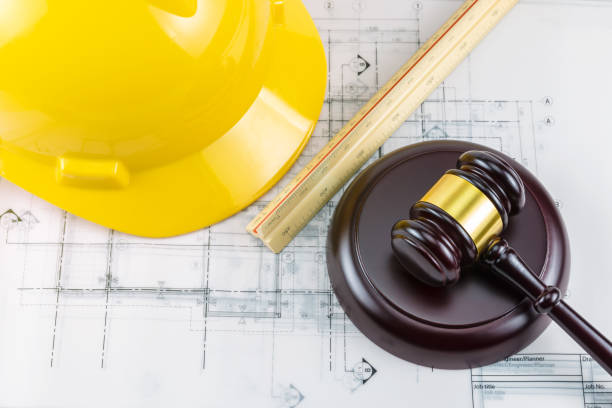 istock Gavel and yellow safety helmet 1062422064