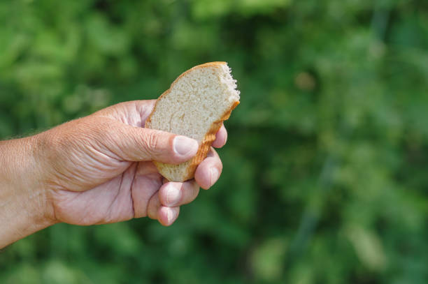 istock Man's hand taking slice of white bread 1062424626