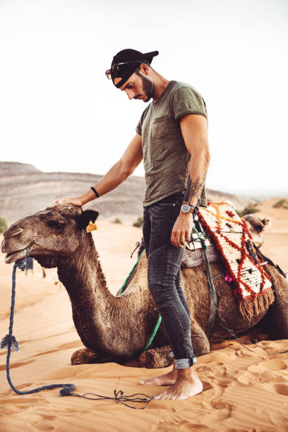 istock man in the desert with camel 1062427548