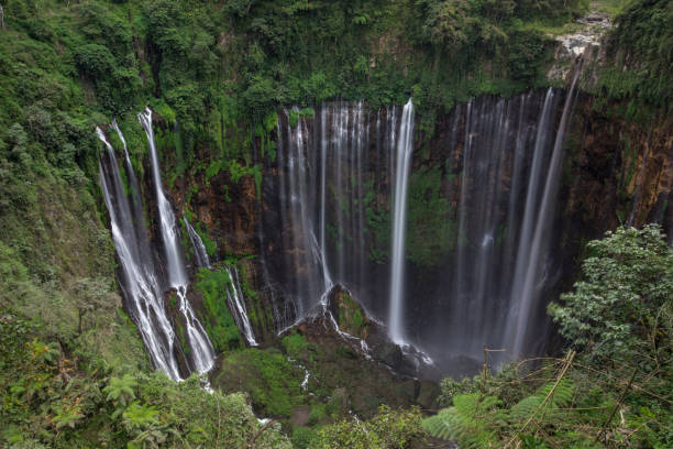 istock Long exposure of the beautiful Coban Sewu waterfall in East Java 1062430024