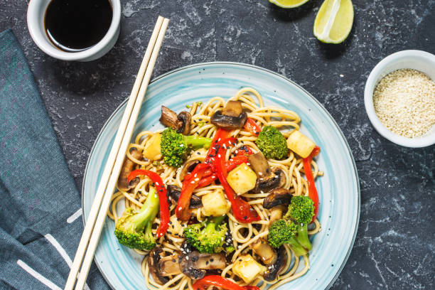 istock Asian tofu soba noodle bowl on stone background. 1062430240