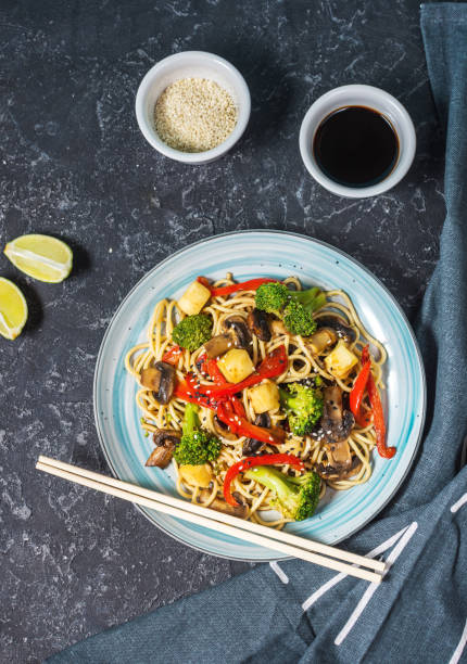 istock Asian tofu soba noodle bowl on stone background. 1062430320