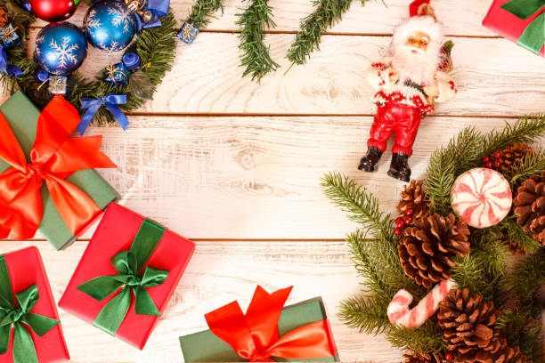 istock Christmas background frame with gift present boxes, fir pine and Santa Claus 1062430508