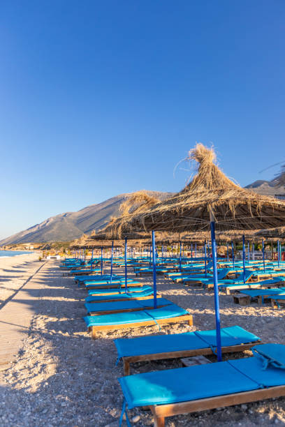 istock Sunrise over an empty beach with umbrellas 1062431170