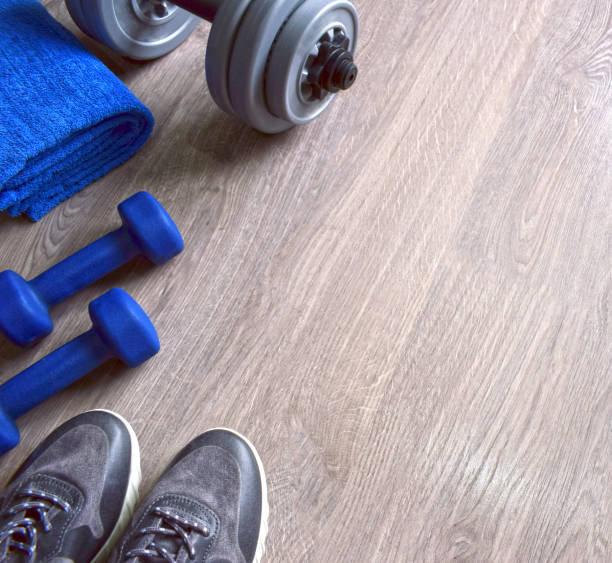 istock Jeans sneakers, dumbbells and blue towel. 1062433344