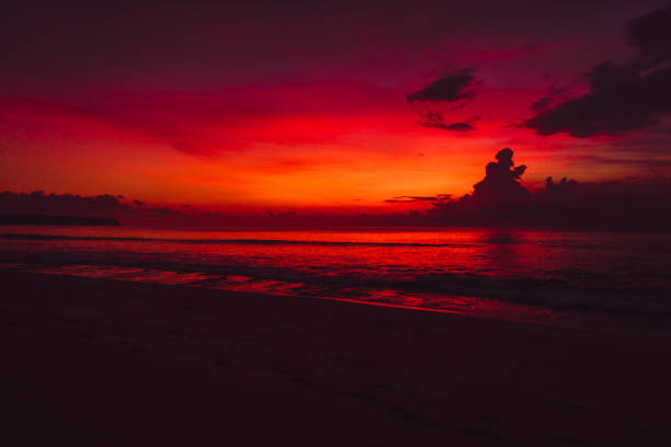 istock Colorful red bright sunset or sunrise at beach with ocean 1062434276