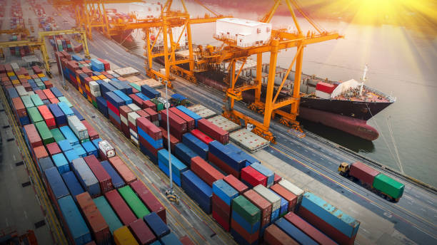 istock Logistics and transportation of Container Cargo ship and Cargo plane with working crane bridge in shipyard at sunrise, logistic import export and transport industry background 1062434514