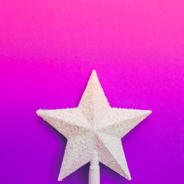 istock shiny white star on purple and pink gradient holographic background. 1062436588
