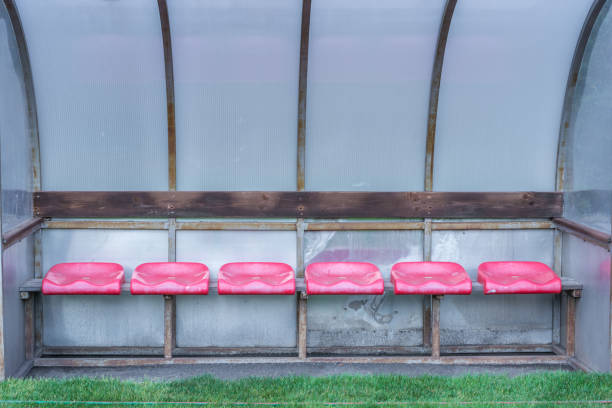 istock Empty spare bench next to a soccer field 1062436824