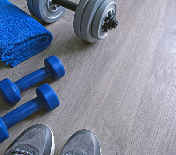 istock Jeans sneakers, dumbbells and blue towel. 1062437072