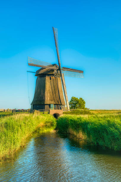 istock Dutch landscape with vintage windmill at sunset (HDRi) 1062439584