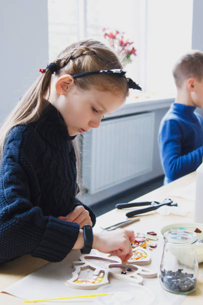 istock The little girl is with a mosaic workshop. 1062448696