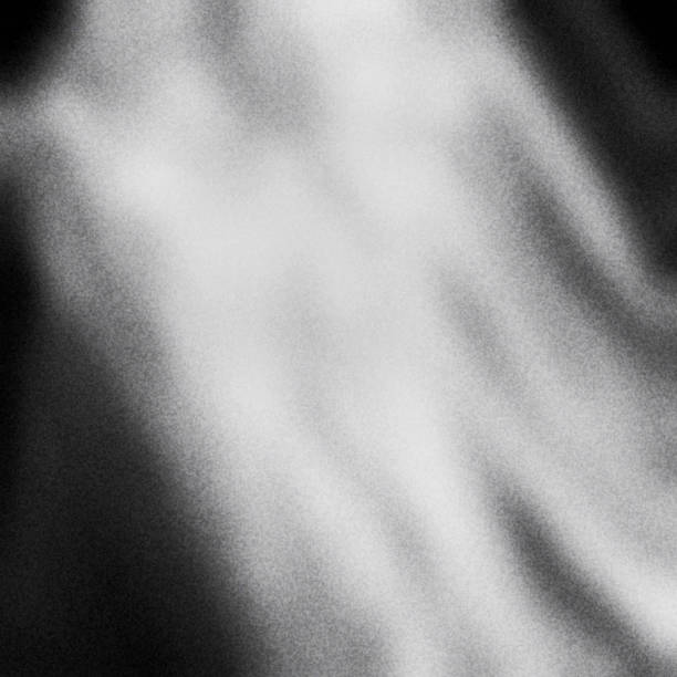 istock Black and white textured background with light leaks and grain. 1062453108