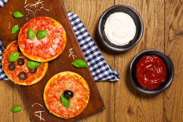 istock Mix of mini pizzas on wooden board 1062454918