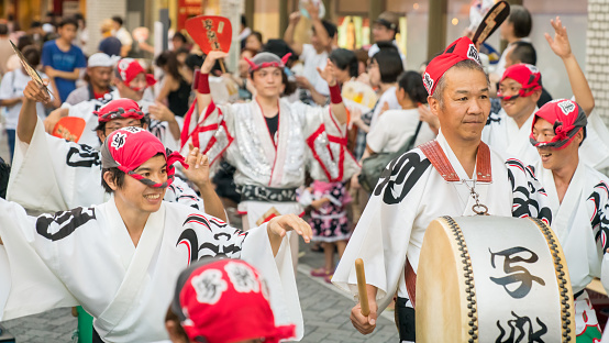 Tokyo, Japan - August 2018: Japanese performers dancing traditional Awaodori dance in the famous Koenji Awa Odori festival.