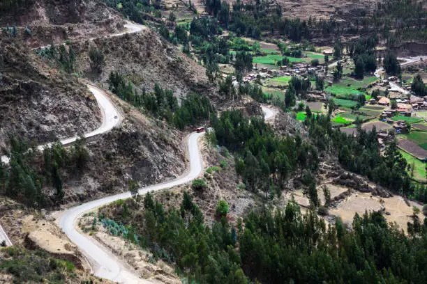 Photo of bus and cars on mountain road on sunny day