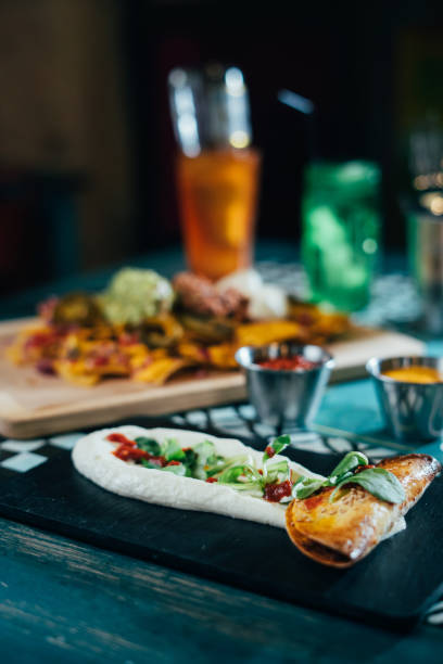 istock Mexican food concept: tortilla chips, guacamole, salsa, chilli with beans and fresh ingredients in a restaurant. 1062456370