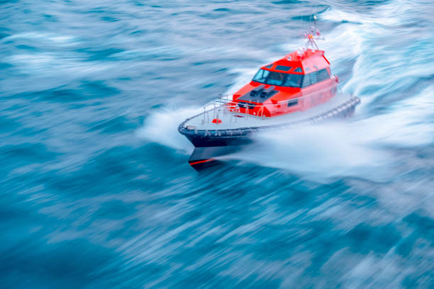 A fast moving orange and white pilot boat