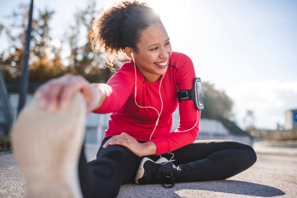 Woman stretching Woman stretching ham strings before a run stretching stock pictures, royalty-free photos & images