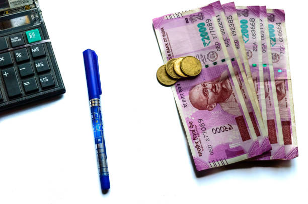 istock Indian paper currency rupees and coins stack, calculator and pen 1062458604