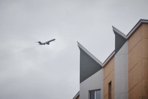 istock The plane flies past the building. 1062462760