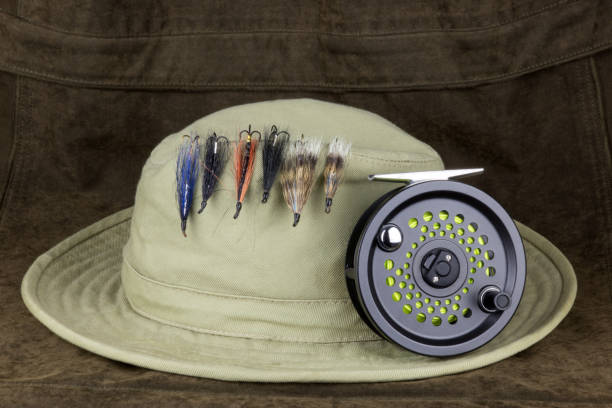 Fishing Flies On Hat With Fly Fishing Reel On Outdoor Coat Stock Photo -  Download Image Now - iStock