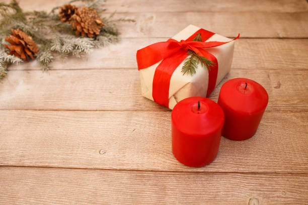istock two burning red candles with fir branches 1062463334