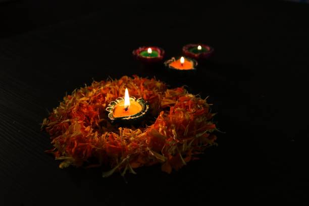 istock Lit diya arranged on a table with flowers 1062463678