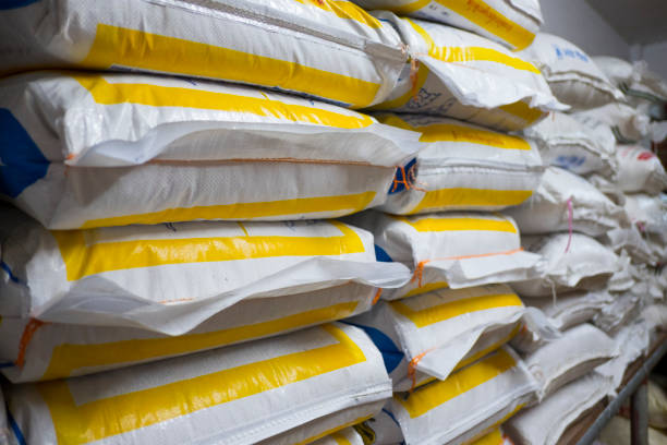 pile of sack in warehouse. background and texture of sack stack in warehouse. - plastic chemical warehouse industry imagens e fotografias de stock
