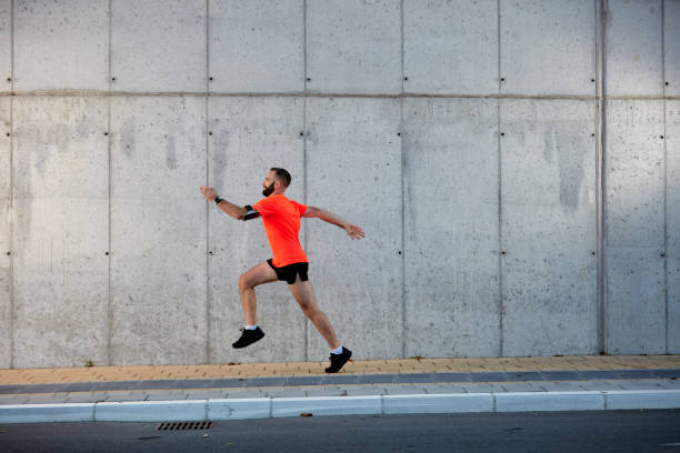 istock Young bearded man running on the street. 1062467772