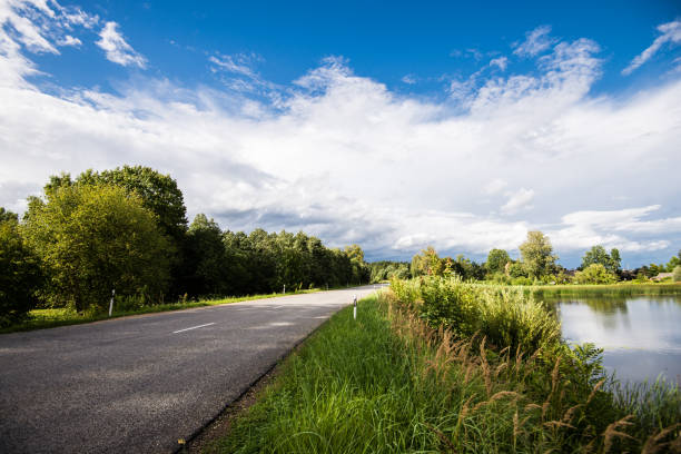 istock An asphalt road through the country fields, Latvia 1062468318
