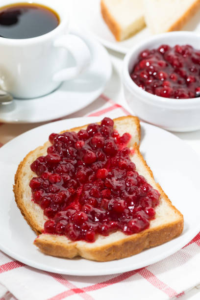toast with cranberry jam for breakfast, vertical closeup
