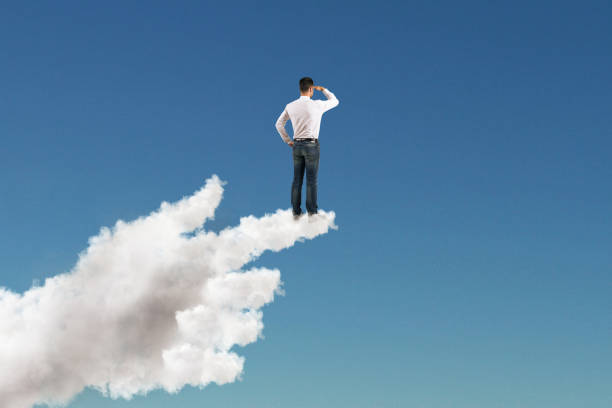 istock businessman staring into the distance on cloud hand 1062474204