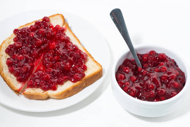 toast with sweet cranberry jam on white table