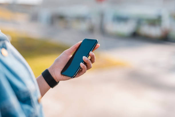 istock Young woman holding a smart phone in her hands 1062478368