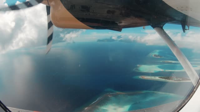 Flying over Maldives Islands with seaplane