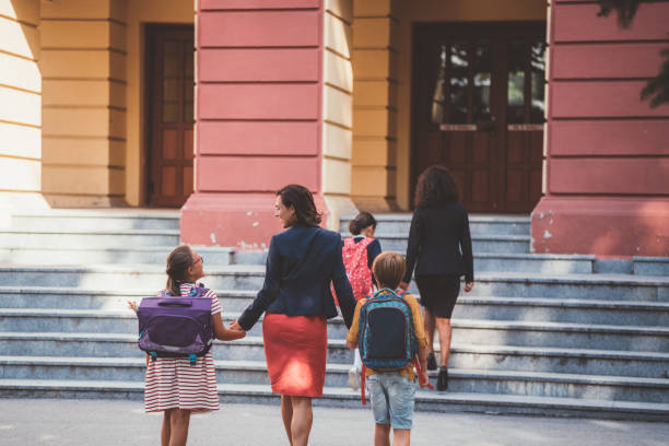 istock Mother leads her children to school 1062482026