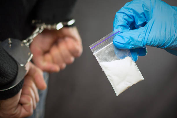police detention drug courier. A police officer finds drugs during the search of drug dealers narcotic photos stock pictures, royalty-free photos & images