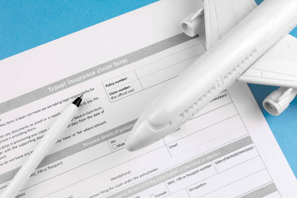 istock Travel preparation concept with insurance  on table. 1062489518