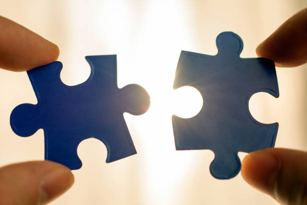 istock holding piece of blue jigsaw puzzle. 1062489646