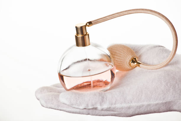 istock glass perfume white gloves hand 1062494472