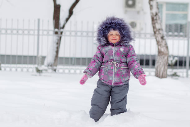 istock Little girl having fun on winter day close to home 1062494708